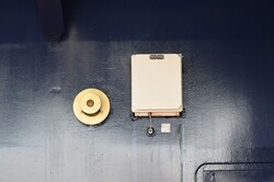 What appears to be an alarm and a equipment box on a cruise ship
