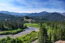 River valley flows through a massive wooded wilderness in the western state of Wyoming.