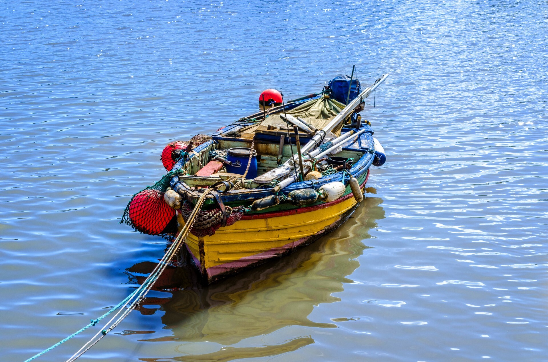 Small fishing boat with fishing net and equipment