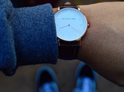 Watch on a mans wrist with the inscription Better Times