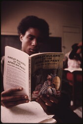 Black student in a Black studies class in a West Side Chicago classroom reading