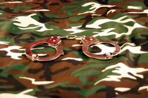 Handcuffs on camouflage