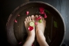 Woman soaking feet at spa
