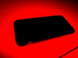Cell Phone - Red Background: Android mobile cell phone with black coloured background