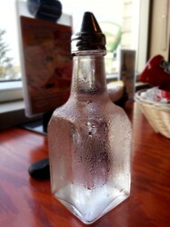 Bottle of vinegar with water droplet over