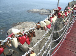 Padlocks shaped as hearts locked on bridge