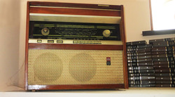 Old Wooden Radio with some Books on a side, Spider Web in a corner