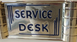Metal antique sign that reads Service Desk