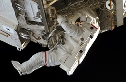 Astronaut working in space on the space station Discovery