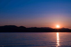 Sunrise over lake and mountains