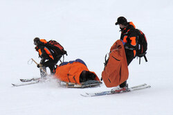 Rescuers taking an injured man to safety