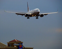 Landing airplane approaching runway just before the dusk