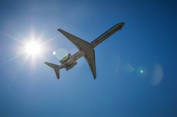 Jet airplane in the sky with sun