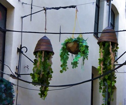 Artistic rendering of upside down pots with ivy plants hanging from them in Brussels, Belgium