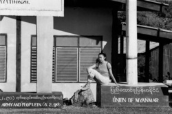 A young woman waiting at the Three Pagodas Pass border post between Thailand and Myanmar