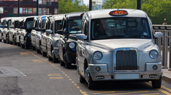 Traditional london taxis in a row