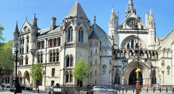 The Royal Courts of Justice, commonly called the Law Courts, is a court building in Westminster which houses the High Court and Court of Appeal of England and Wales. The High Court also sits on circuit and in other major cities. Designed by George Edmund Street, who died before it was completed, it is a large grey stone edifice in the Victorian Gothic Revival style built in the 1870s and opened by Queen Victoria in 1882. It is one of the largest courts in Europe. It is a Grade I listed building.