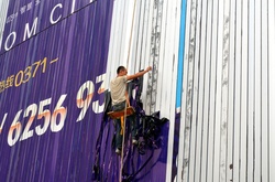 Workmen remove advert