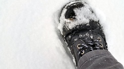Close up of a walking boot stepping in snow. Thnx for looking at my pics and my tips