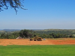 Open ground with earth mover preparing a field