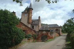 A Tower and houses in the village of Collonges la rouge, photographed in August 2000