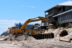 Backhoe working on the beach for beach erosion