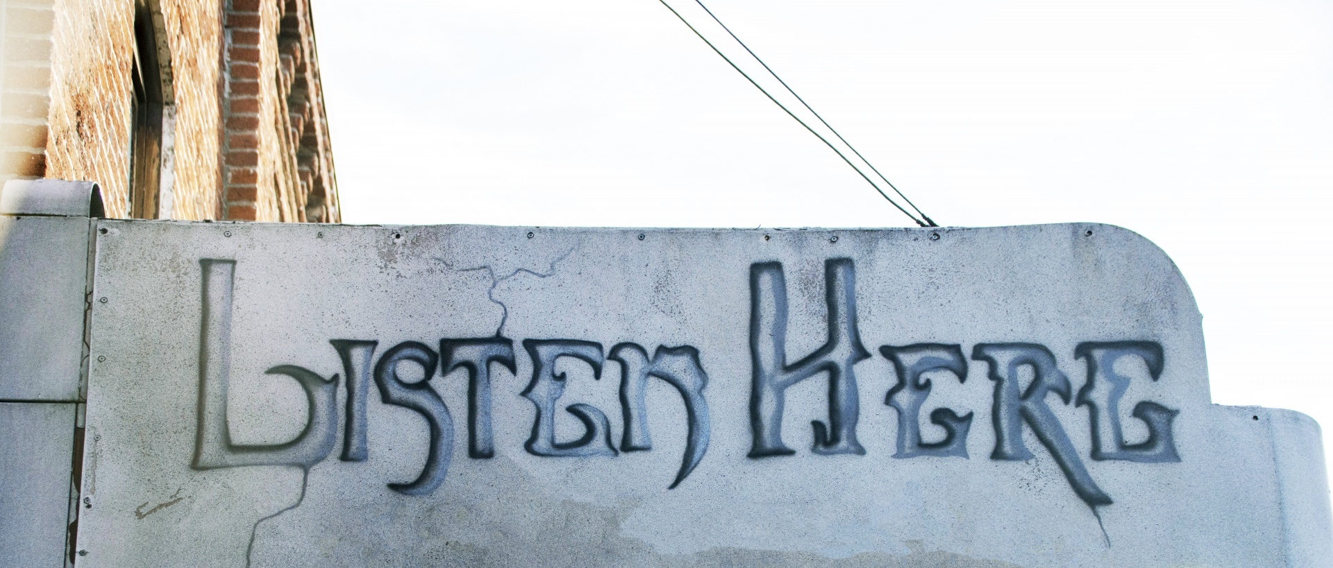 Sign that reads listen here