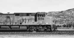 Black and white photograph of a passing train