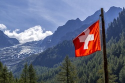 A Swiss flag on a flagpole