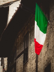 Italian flag hanging on an old wall