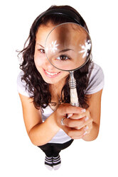 Young woman with magnifying glass