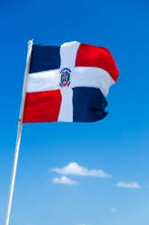 Dominican republic flag against blue sky