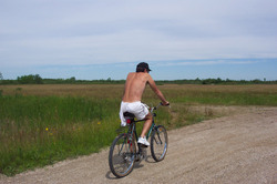 Man cycling down side road