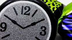 Close-up of glittery new year clock and bright party favor popper