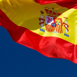 Spanish flag against blue sky