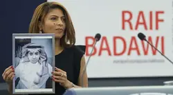Ensaf Haidar, the wife of jailed Saudi Arabian blogger Raif Badawi, poses with a portrait of her husband as she receives the 2015 Sakharov Prize on his behalf during a ceremony at the European Parliament in Strasbourg