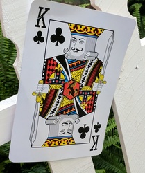 Cards from a deck pinned on a fence for decoration