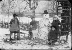 J. H. Aho, children building a snowman (Finland)