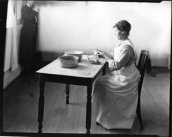 Miss Ruth Kellogg demonstrating correct postures for housework
