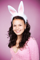Young woman wearing pink easter bunny costume