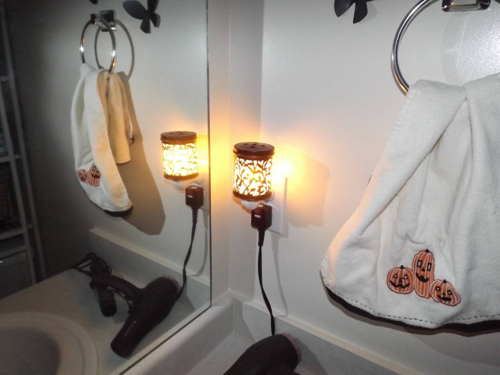 Plugged in wax-light in a dark bathroom