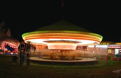A carnival ride photographed in a time exposure, Anniston, Ala.