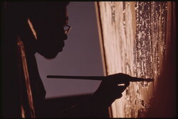 Artist Ron Blackburn painting an outdoor wall mural at the corner of 33rd and Giles