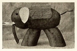 The elephant is made from a big pear and a small apple skewered together and mounted on two pieces of banana.