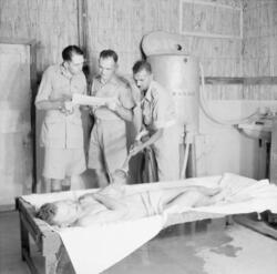 The British Army in the Middle East 1943 One of a series of photographs demonstrating the treatment given for sufferers of heat stroke in Iraq. This patient is being sprayed with cool water, 20 September 1943.