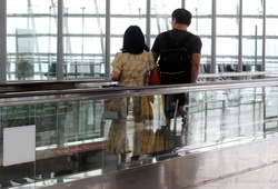 Passengers at an Airport on a Moving Walkway