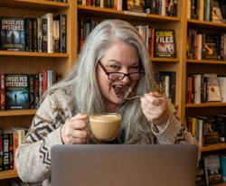 Woman having cake and coffee in the library