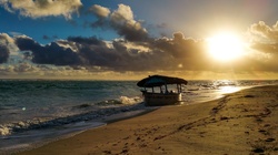 Small boat at sunrise in Caribbean