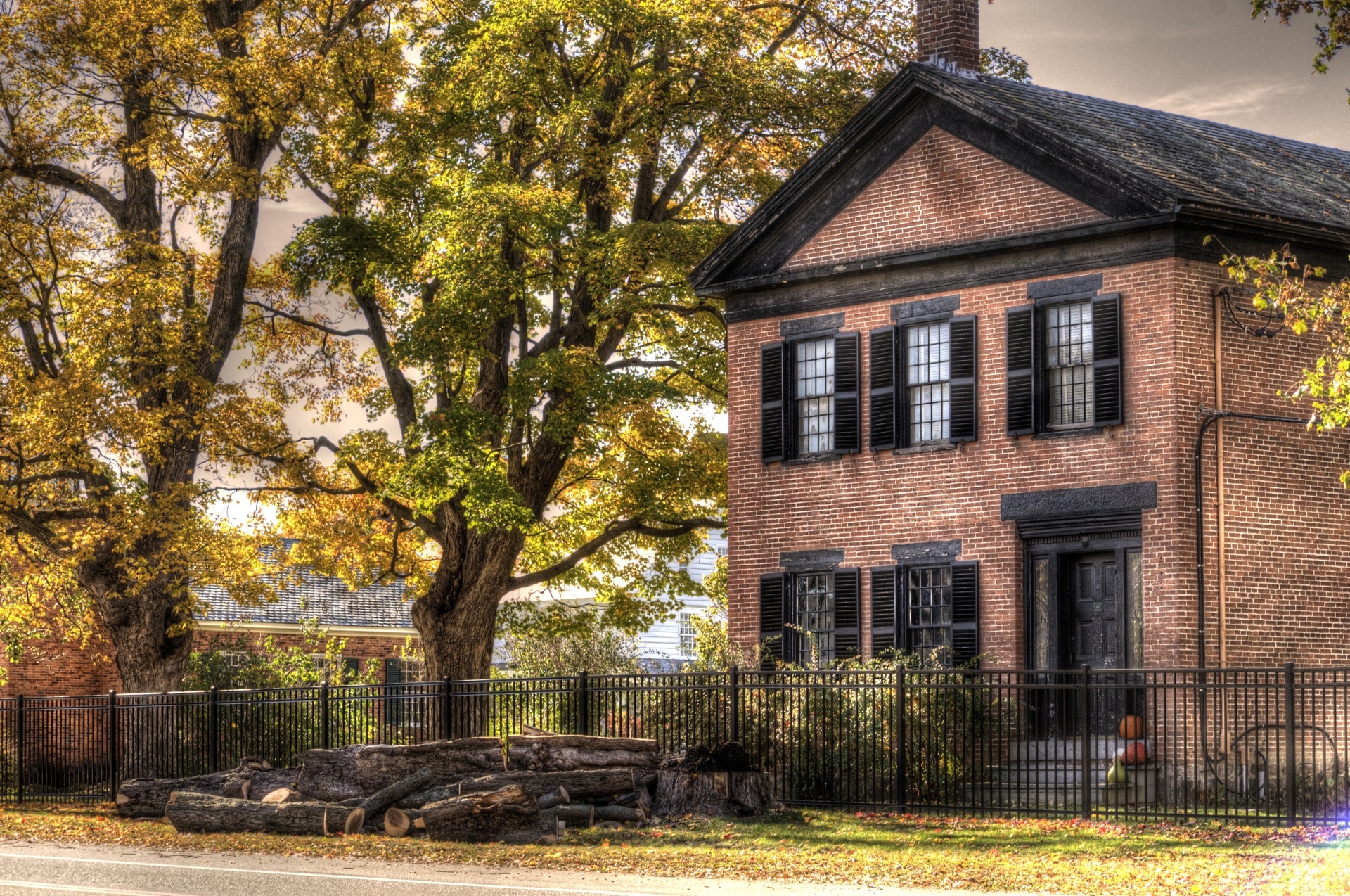Artistic touch applied to photograph of a New England Brick house in the fall