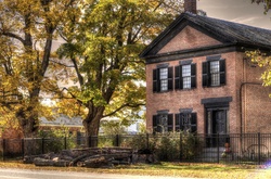 Artistic touch applied to photograph of a New England Brick house in the fall